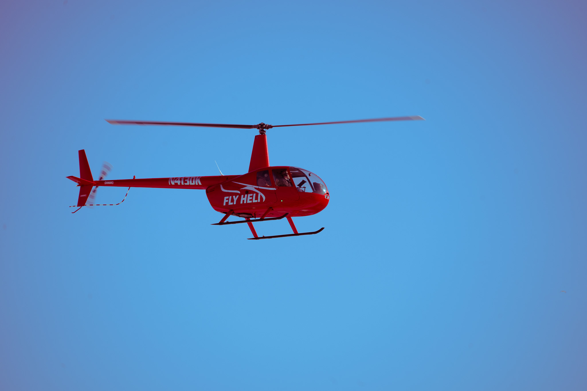 Red helicopter in flight